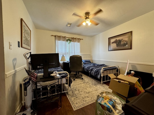 bedroom featuring dark hardwood / wood-style floors and ceiling fan