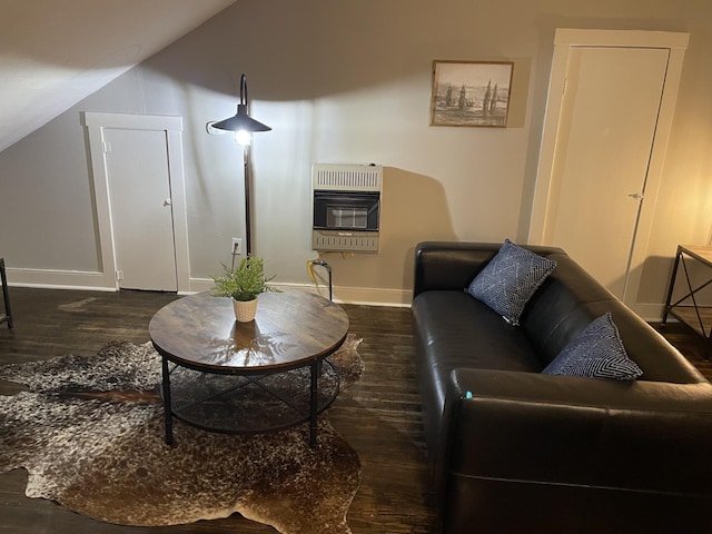 living room with heating unit, dark wood-type flooring, and vaulted ceiling