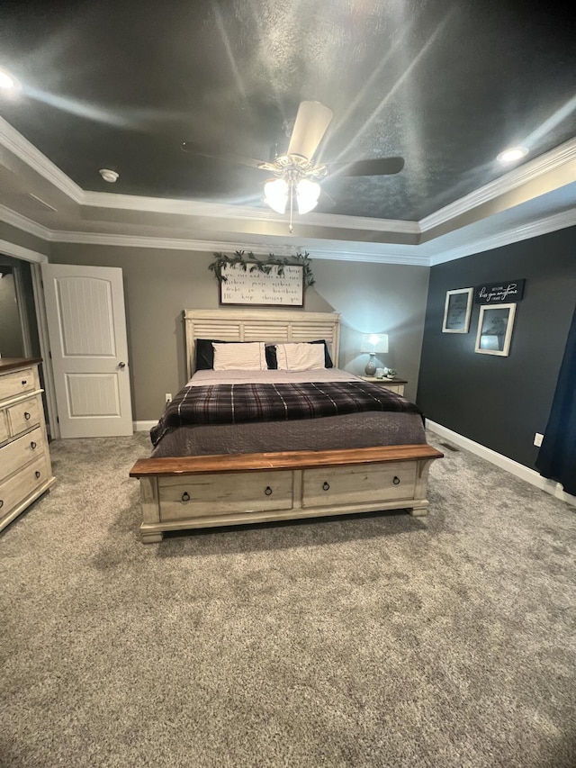 carpeted bedroom with crown molding, a textured ceiling, ceiling fan, and a tray ceiling