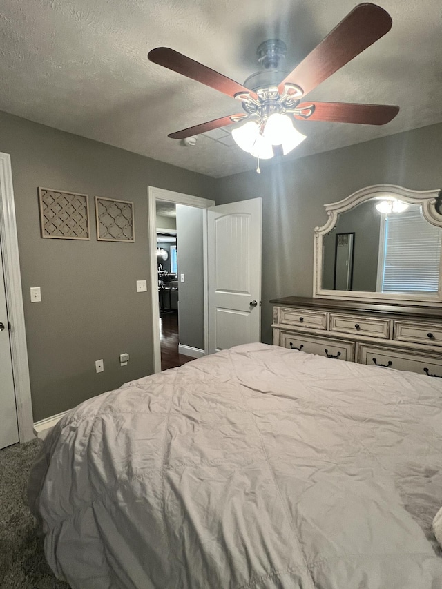 bedroom featuring a textured ceiling, ceiling fan, and carpet flooring