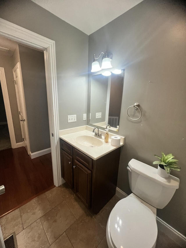 bathroom with vanity, tile patterned floors, and toilet