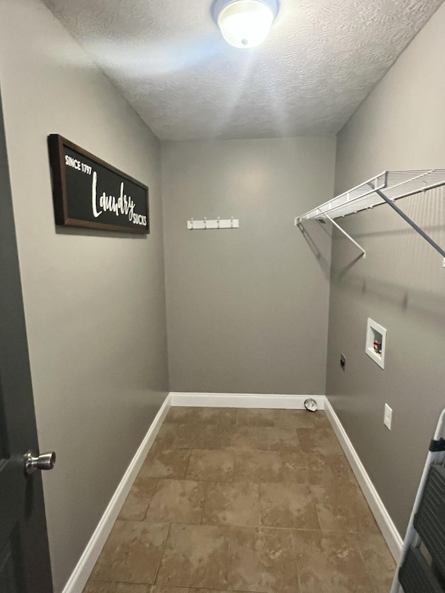 laundry area featuring washer hookup, electric dryer hookup, and a textured ceiling