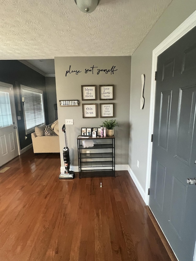 entryway featuring dark hardwood / wood-style floors and a textured ceiling