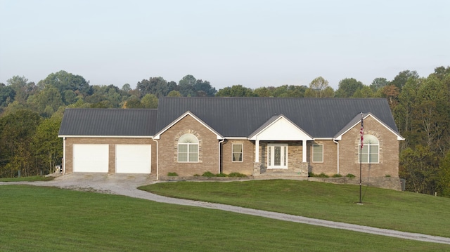 single story home with driveway, brick siding, an attached garage, and a front yard