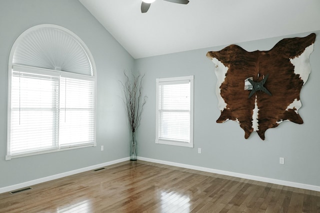 unfurnished room featuring wood-type flooring, ceiling fan, and lofted ceiling