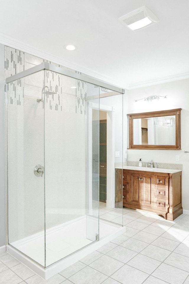 bathroom featuring a shower with door, vanity, and ornamental molding