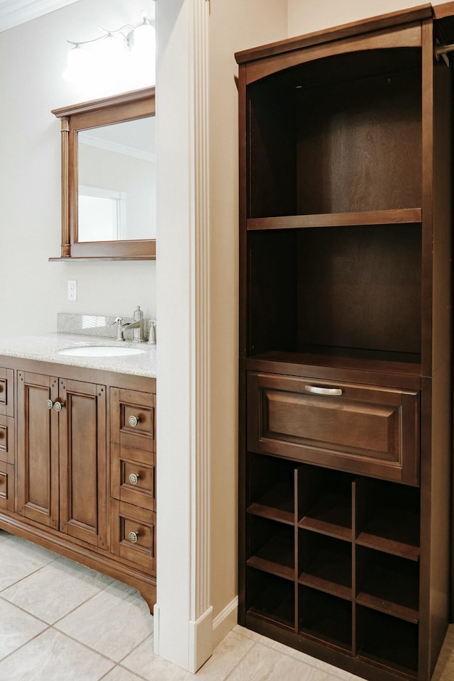 bathroom with vanity, ornamental molding, and tile patterned floors