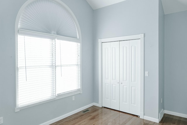 unfurnished bedroom with hardwood / wood-style flooring and a closet