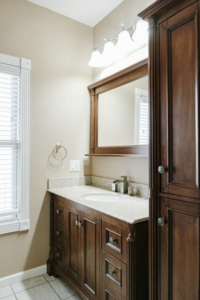 bathroom featuring vanity, a wealth of natural light, and tile patterned flooring