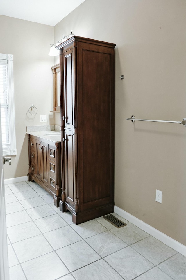 bathroom with tile patterned flooring and vanity