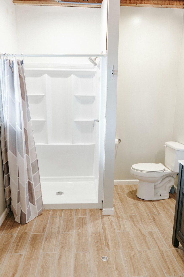 bathroom featuring toilet and walk in shower