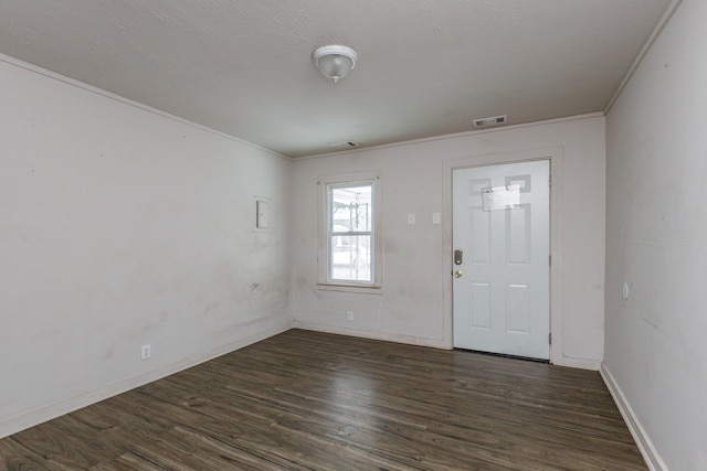 entrance foyer featuring crown molding and dark hardwood / wood-style floors