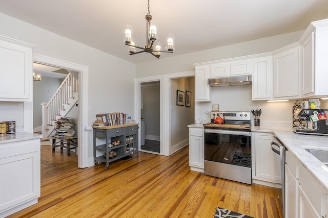 kitchen featuring white cabinetry, light hardwood / wood-style flooring, stainless steel appliances, and a chandelier