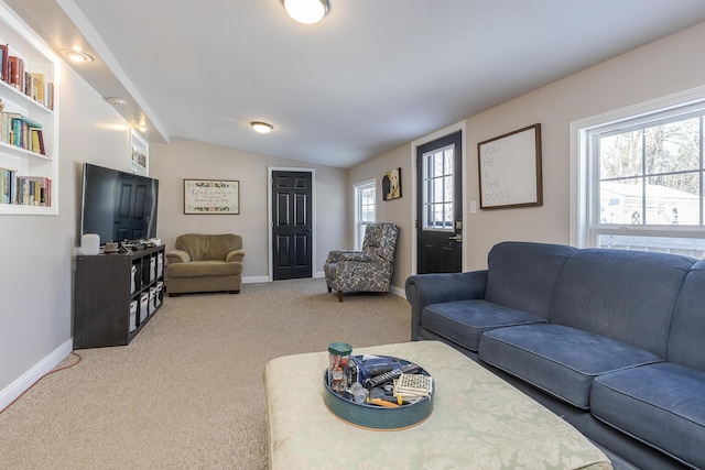 living room featuring vaulted ceiling and carpet flooring