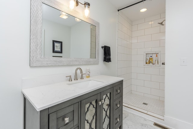 bathroom featuring vanity and a tile shower