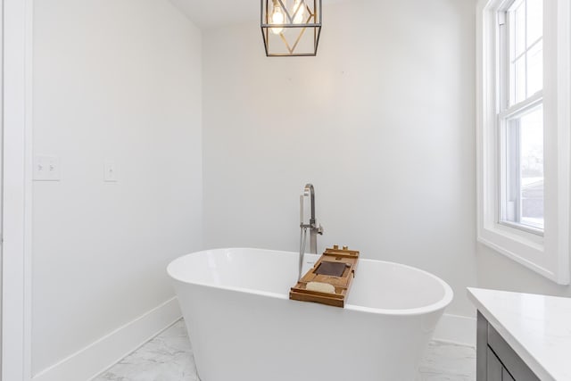 bathroom featuring a tub to relax in and vanity