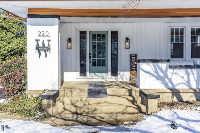 view of snow covered property entrance