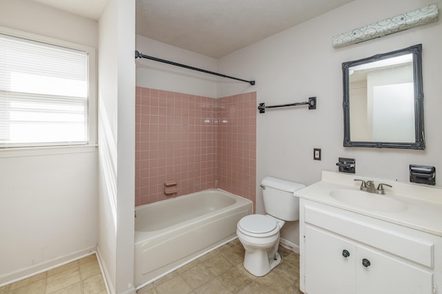 full bathroom featuring a textured ceiling, toilet, vanity, and tiled shower / bath combo