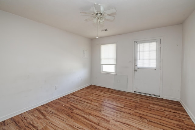 spare room with light wood-type flooring and ceiling fan