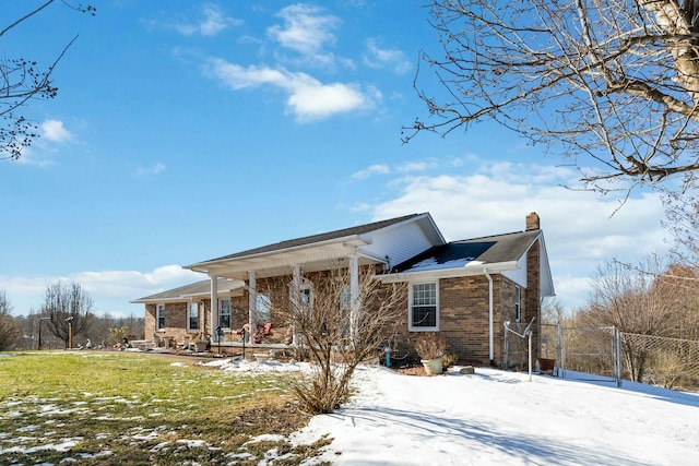 view of front of home with a porch and a yard