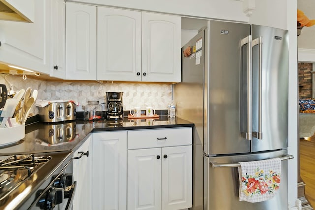 kitchen with tasteful backsplash, stainless steel appliances, and white cabinetry