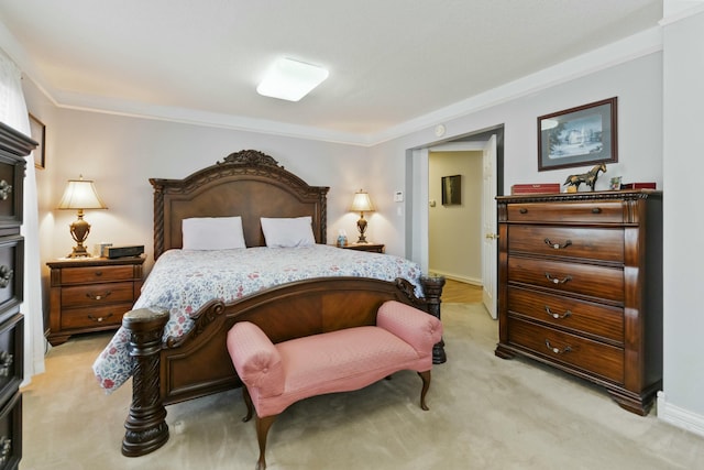 bedroom featuring ornamental molding and light colored carpet