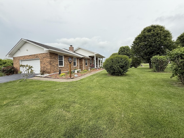 451 Parkside Rd, London, KY 40744 - view of front of home featuring brick siding, a chimney, a front yard, a garage, and driveway