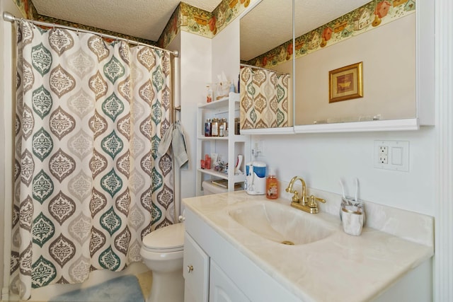 bathroom with a textured ceiling, toilet, and vanity