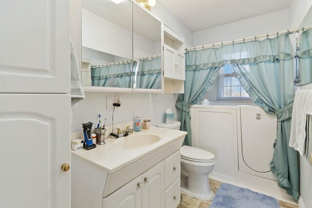 bathroom with toilet, vanity, and curtained shower