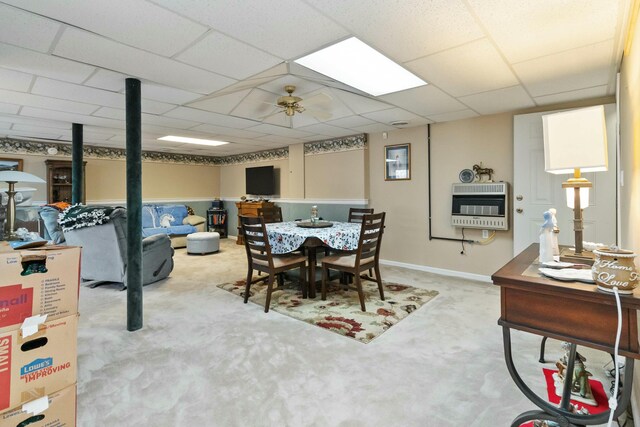 dining room featuring light carpet, a paneled ceiling, heating unit, and ceiling fan