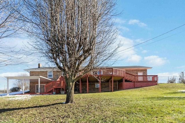 rear view of property featuring a deck and a lawn