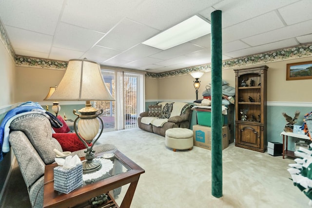 carpeted living room featuring a paneled ceiling