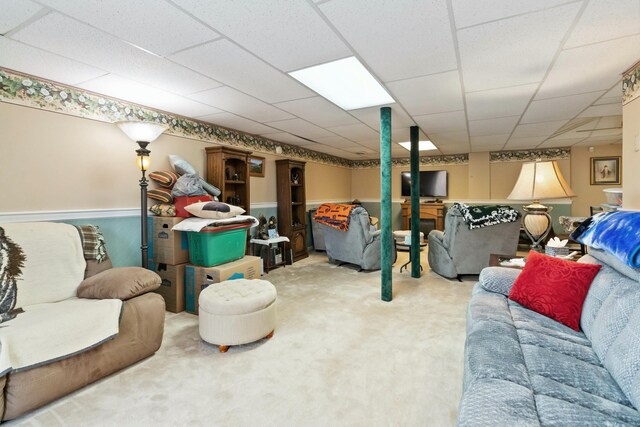 living room featuring a paneled ceiling and carpet