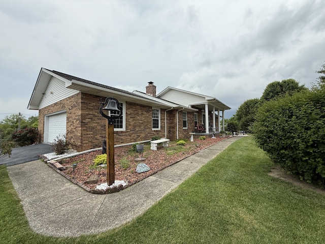 451 Parkside Rd, London, KY 40744 - view of side of home with brick siding, a chimney, a yard, and asphalt driveway