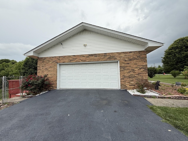 451 Parkside Rd, London, KY 40744 - view of home's exterior with brick siding, driveway, a garage, and fence