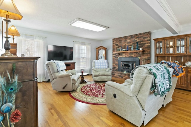 living room featuring plenty of natural light, crown molding, a textured ceiling, and light hardwood / wood-style flooring