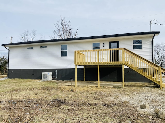 back of house featuring ac unit and a deck