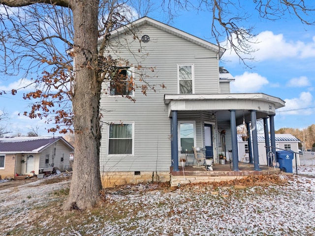 snow covered property featuring covered porch