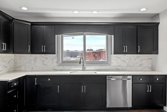 kitchen featuring tasteful backsplash, sink, and stainless steel dishwasher