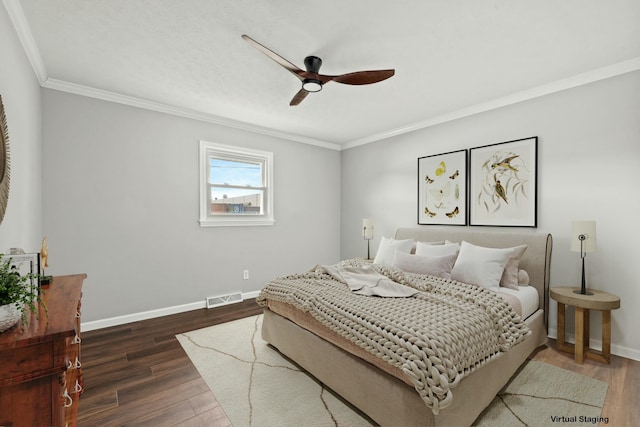 bedroom with crown molding, dark hardwood / wood-style floors, and ceiling fan