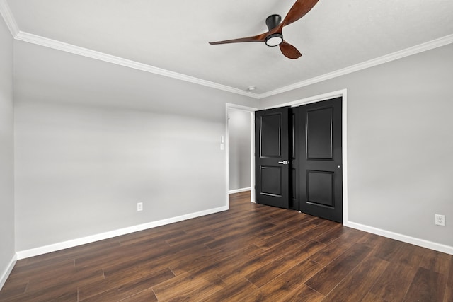 unfurnished bedroom featuring crown molding, dark wood-type flooring, and ceiling fan