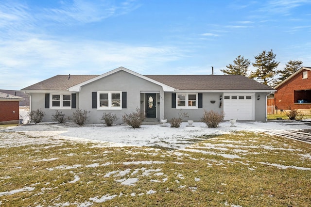 ranch-style home with a garage and a lawn