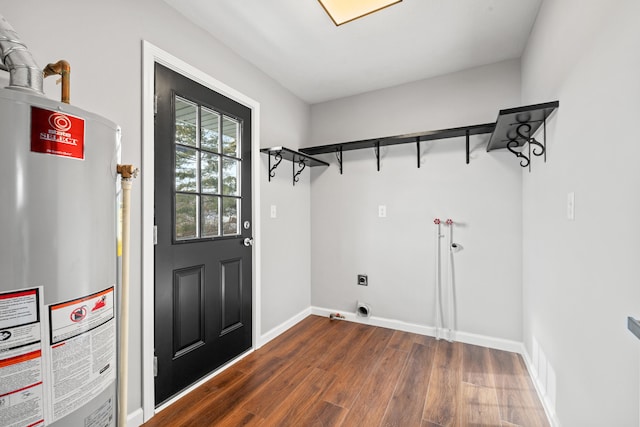 laundry room with electric dryer hookup, dark wood-type flooring, and water heater