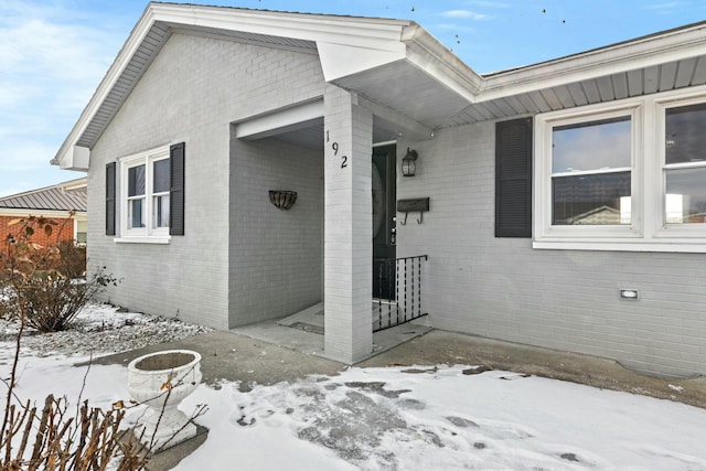 view of snow covered property entrance