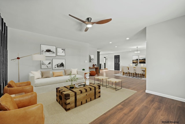 living room featuring hardwood / wood-style flooring and ceiling fan