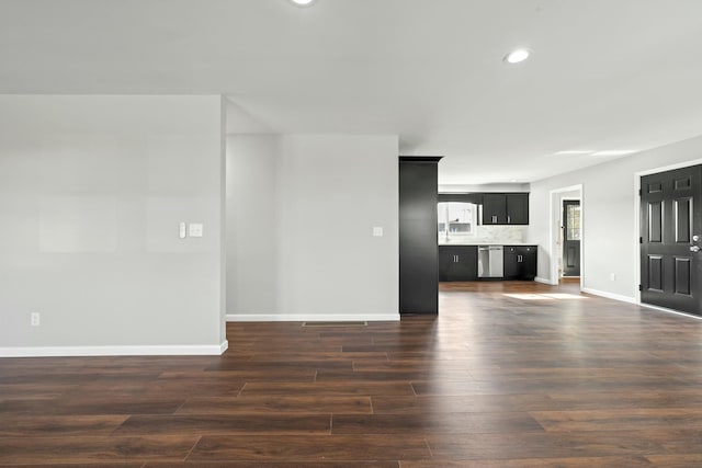 unfurnished living room with dark wood-type flooring