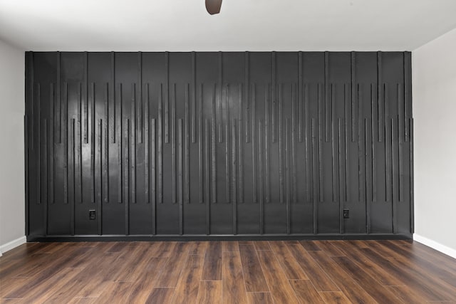 spare room featuring radiator and dark hardwood / wood-style flooring