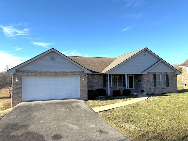 ranch-style home featuring a garage and a front yard