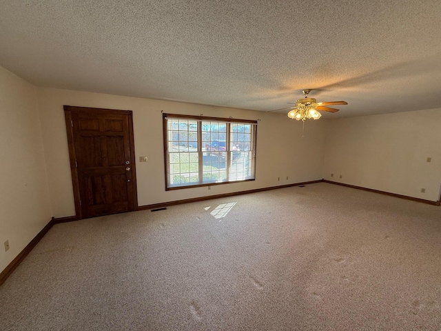 unfurnished room featuring ceiling fan, carpet flooring, and a textured ceiling