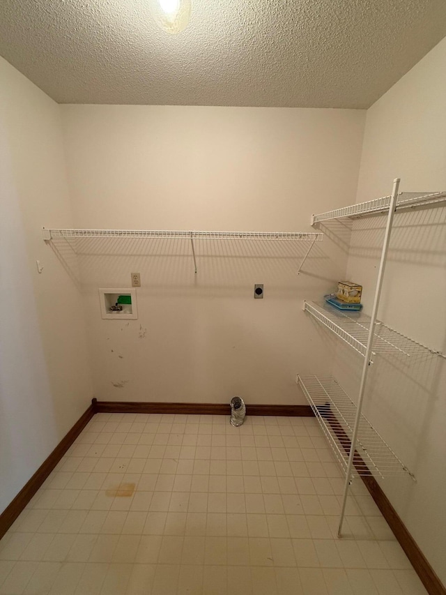 laundry room featuring hookup for a washing machine, hookup for an electric dryer, and a textured ceiling